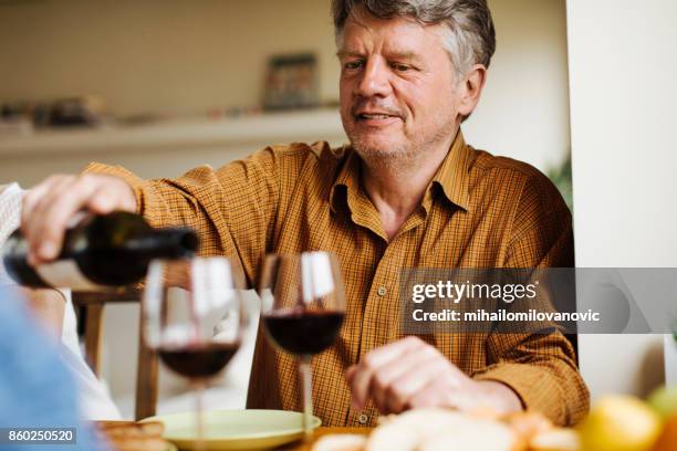 dinner and wine - only senior men stock pictures, royalty-free photos & images