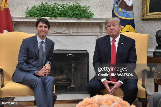 President Donald Trump and Canadian Prime Minister Justin Trudeau look on during their meeting at the White House in Washington, DC, on October 11,...