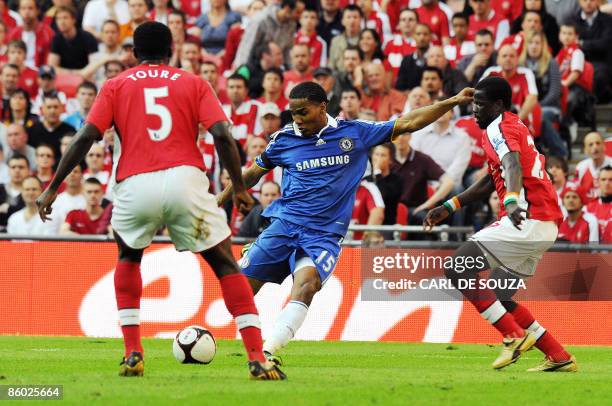 Chelsea's French player Florent Malouda scores the second goal of the match past Arsenal's Ivorian defender Kolo Toure and Arsenal's Ivorian...