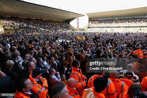 Wolverhampton Wanderers fans cover the pitch after the final whistle to celebrate after winning promotion to the Premier League after the Coca Cola...