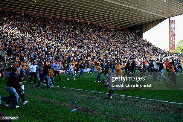Wolverhampton Wanderers fans invade the pitch at the final whistle to celebrate after winning promotion to the Premier League after the Coca Cola...