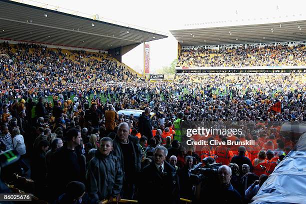 Wolverhampton Wanderers fans cover the pitch after the final whistle to celebrate after winning promotion to the Premier League after the Coca Cola...