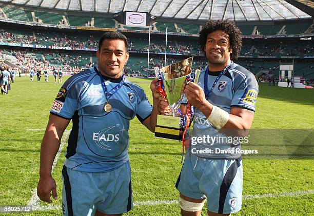 Taufa'ao Filise and Ma'ama Molitika of Cardiff pose with the trophy following their team's victory during the EDF Energy Cup Final between Gloucester...