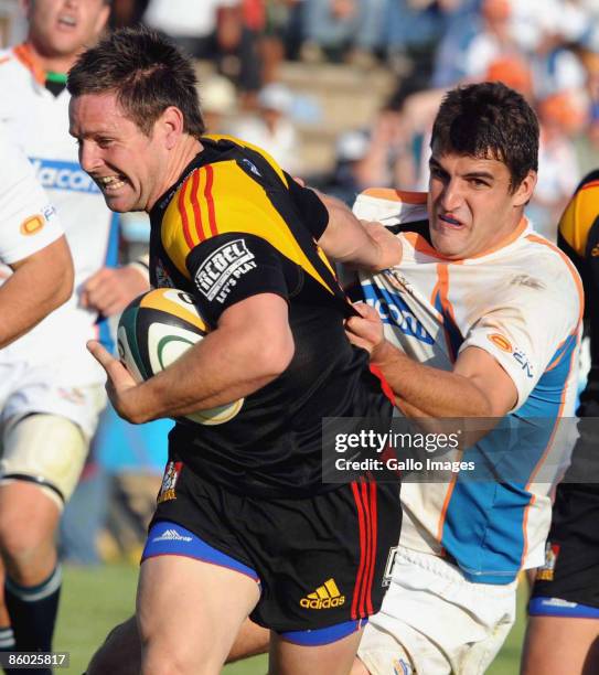 Mike Delany of Chiefs tackled by Hennie Daniller of Cheethas during the Super 14 match between Cheetahs and Chiefs from GWK Stadium on 18 April 2009...