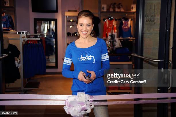 Actress Alyssa Milano cuts the ribbon at the grand opening of Touch Boutique at Citi Field on April 18, 2009 in New York City.