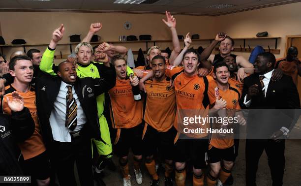 In this handout photo provided by Wolverhampton Wanderers Football Club, Wolverhampton Wanderers players celebrate in the dressing room after winning...