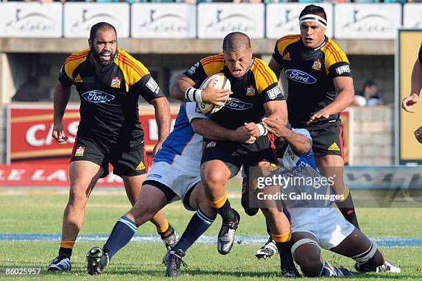 Wian du Preez and Wayne van Heerden of Cheetahs tackle Hika Elliot of Chiefs during the Super 14 rugby match between Cheetahs and Chiefs at GWK...