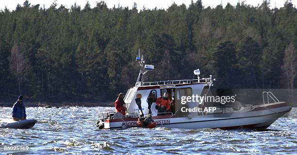 Rescue diver jumps into the water during rescue efforts after a boating accident in Lake Vanern north of Mariestad in south west Sweden April 18,...