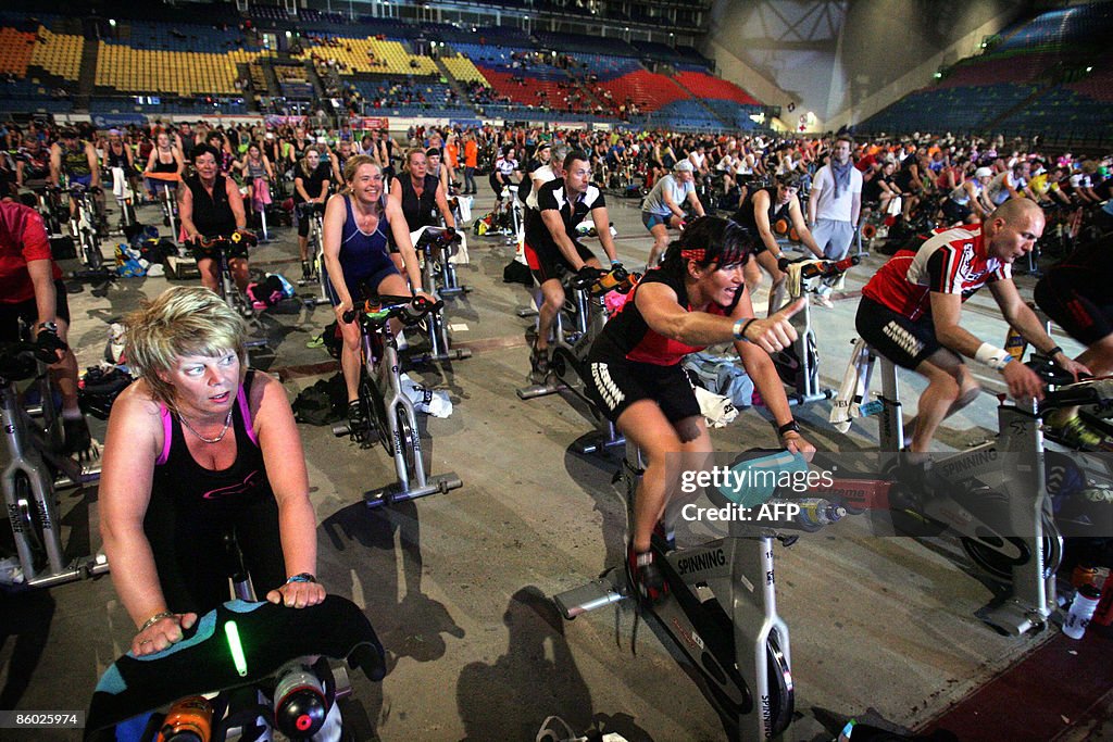 Trainers in action on spinning bikes in