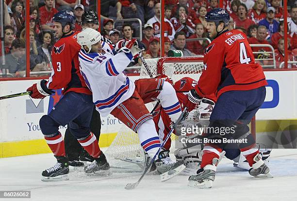 Scott Gomez of the New York Rangers is hit by John Erskine of the Washington Capitals during Game Two of the Eastern Conference Quarterfinal Round of...