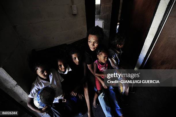 Delice looks on as she sits on April 15, 2009 with 5 of her 6 children in her newly built house at the Tafelsig township in Mitchells plain on the...