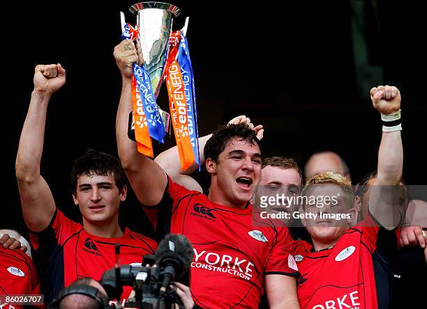 Hartpury captain, Andries Pretorious celebrates with teammates as he lifts the trophy following their team's victory during the EDF Energy...