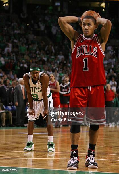 Rajon Rondo of the Boston Celtics looks on as Derrick Rose of the Chicago Bulls prepares to shoot a free throw in the final minute of overtime in...