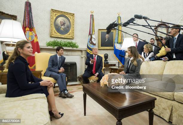 President Donald Trump, second right, speaks next to U.S. First Lady Melania Trump, right, while meeting with Justin Trudeau, Canada's prime...
