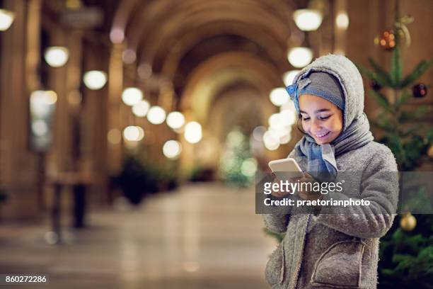 little gir is texting in the bezistan at christmas - uzbekistan stock pictures, royalty-free photos & images