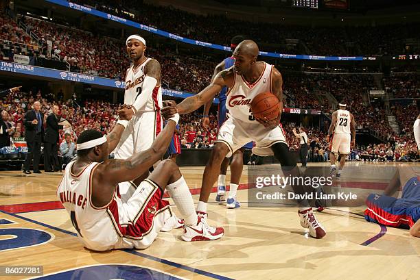 Ben Wallace of the Cleveland Cavaliers gets some help from teammates Mo Williams and Joe Smith after he takes a charge against the Detroit Pistons in...