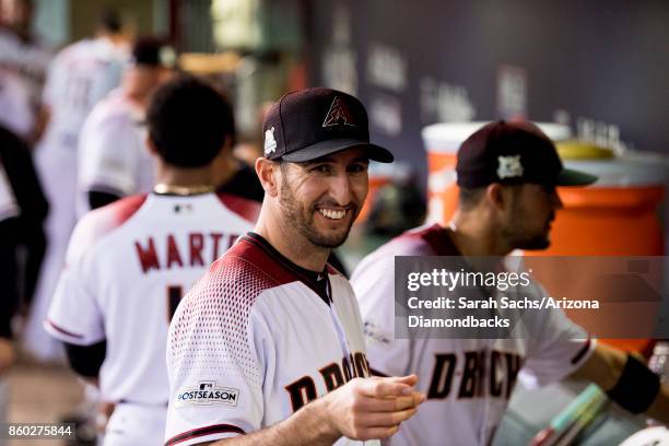 Adam Rosales of the Arizona Diamondbacks hangs out in the dugout during game three of the National League Divisional Series against the Los Angeles...