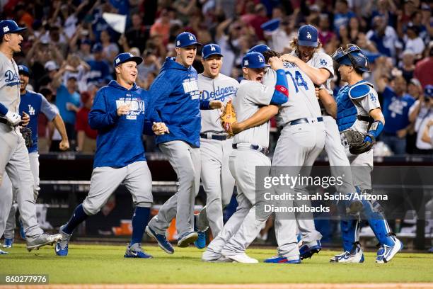 The Los Angeles Dodgers celebrate after defeating the Arizona Diamondbacks in game three of the National League Divisional Series at Chase Field on...