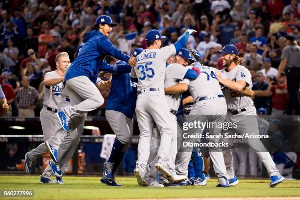 The Los Angeles Dodgers celebrate after defeating the Arizona Diamondbacks in game three of the National League Divisional Series at Chase Field on...