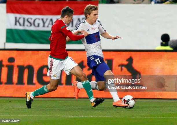 Adam Nagy of Hungary competes for the ball with Joan Edmundsson of Faroe Islands during the FIFA 2018 World Cup Qualifier match between Hungary and...