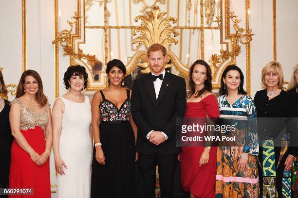 Prince Harry poses for a photo with Amanda Pullinger, Chief Executive Officer of 100 Women in Finance and Sonia Gardner as he attends 100 Women in...