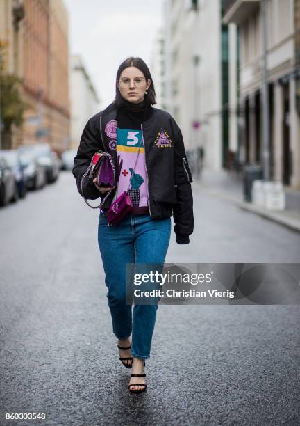 Fashion blogger Maria Barteczko wearing an embroidered black bomber jacket with patches Givenchy, colorful turtle neck knitwear Valentino, high...