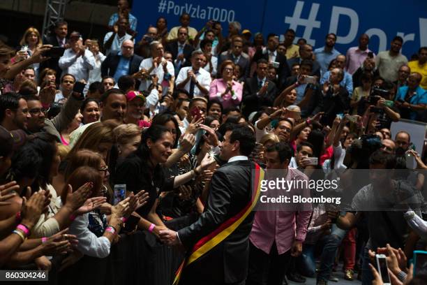Henrique Capriles, opposition leader and governor of the State of Miranda, center, greets attendees during an event marking his last day as governor...