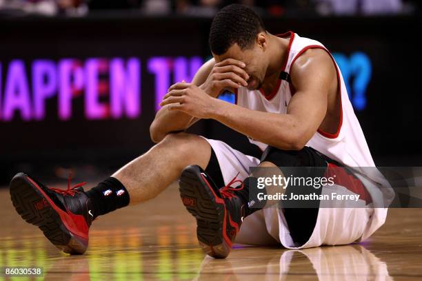 Brandon Roy of the Portland Trail Blazers holds his face after being injured during a scramble for the ball against the Houston Rockets during Game...