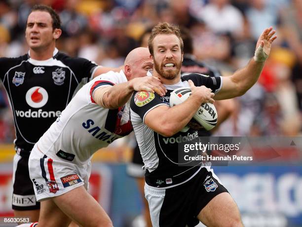 Craig Fitzgibbon of the Roosters holds onto Ian Henderson of the Warriors during the round six NRL match between the Warriors and the Sydney Roosters...