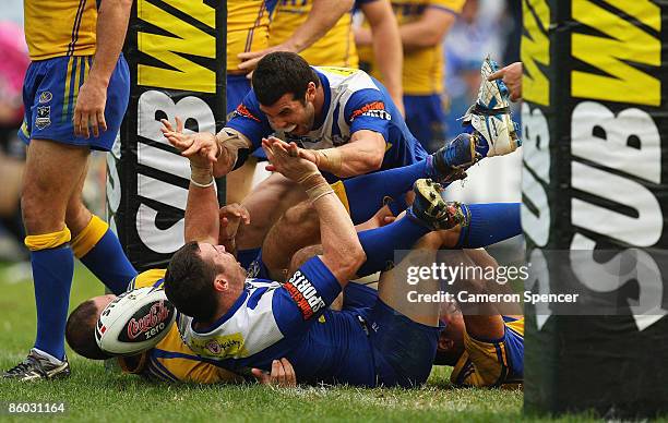 Michael Hodgson of the Bulldogs celebrates scoring a try with team mate Michael Ennis during the round six NRL match between the Parramatta Eels and...