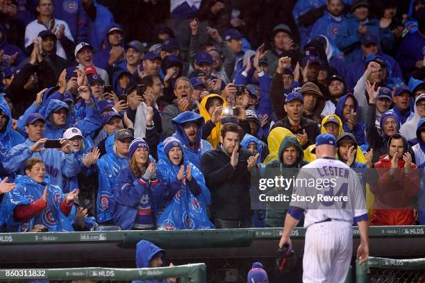 Jon Lester of the Chicago Cubs receives a standing ovation after being relieved in the eighth inning during game four of the National League Division...