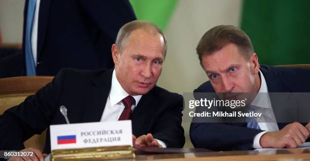 Russian President Vladimir Putin and First Deputy Prime Minister Igor Shuvalov enter the hall during the CIS Summit October 12, 2017 in Sochi,...