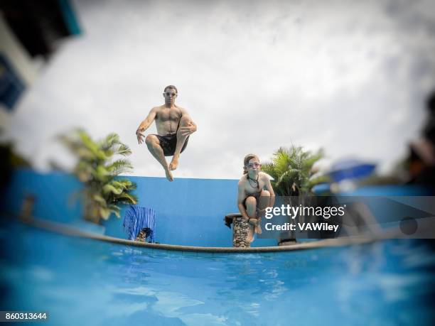 cannonball kid and dad - cannonball diving stock pictures, royalty-free photos & images