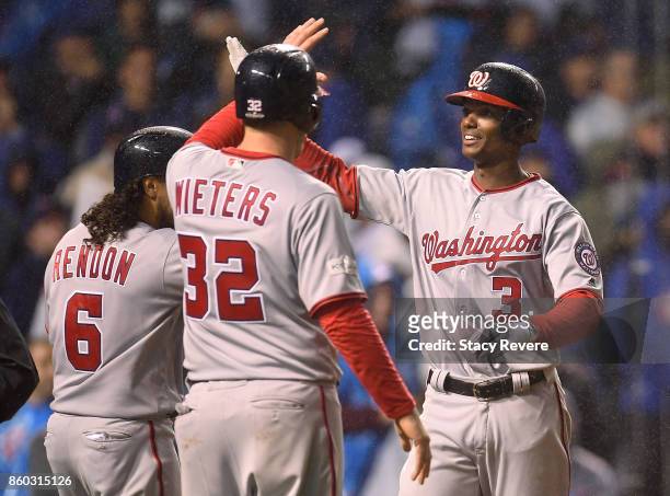 Michael A. Taylor of the Washington Nationals celebrates with Anthony Rendon and Matt Wieters after hitting a grand slam in the eighth inning during...