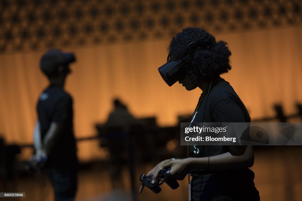 Connect Oculus Rift In An attendee operates the Oculus VR Inc. Rift virtual reality headset ...