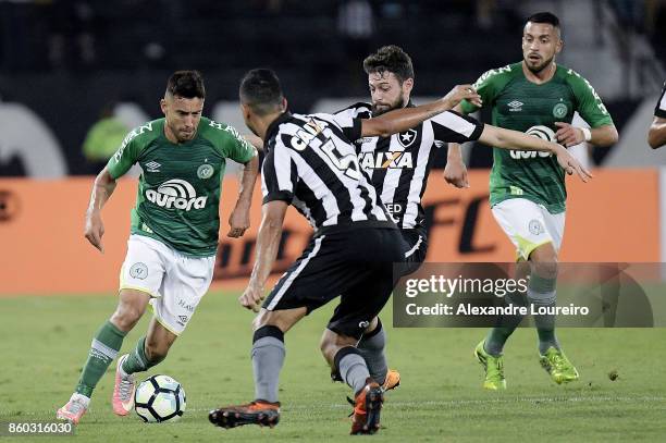 Joao Paulo of Botafogo battles for the ball with Alan Ruschel of Chapecoense during the match between Botafogo and Chapecoense as part of Brasileirao...