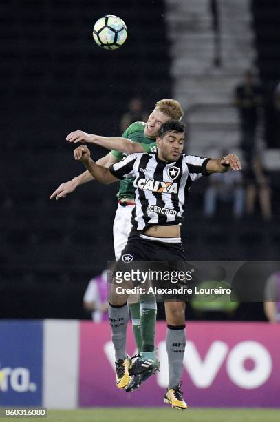 Brenner of Botafogo battles for the ball with Douglas Grolli of Chapecoense during the match between Botafogo and Chapecoense as part of Brasileirao...