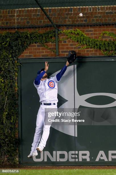 Ian Happ of the Chicago Cubs fails to catch a grand slam hit by Michael Taylor of the Washington Nationals in the eighth inning during game four of...