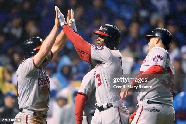 Daniel Murphy and Michael A. Taylor of the Washington Nationals celebrate after Taylor hit a grand slam in the eighth inning during game four of the...