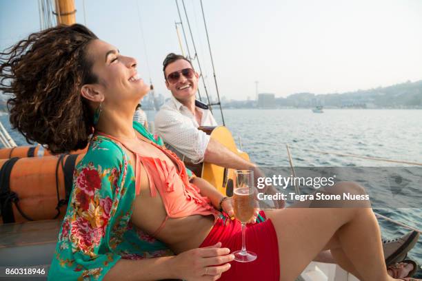 couple celebrating on a sailboat - högt hårfäste bildbanksfoton och bilder