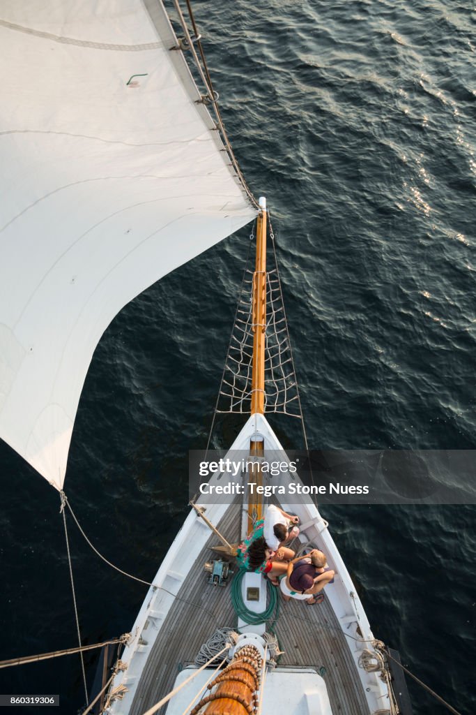 Friends on bow of large sailboat