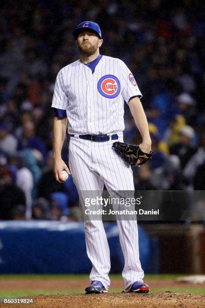 Wade Davis of the Chicago Cubs looks on after giving up a grand slam in the eighth inning during game four of the National League Division Series...