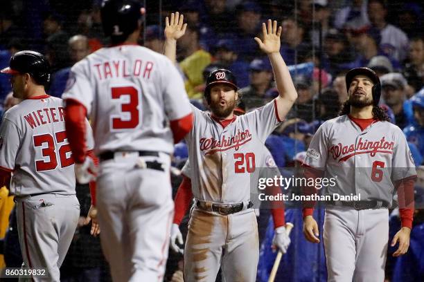 Matt Wieters, Daniel Murphy and Anthony Rendon of the Washington Nationals wait for Michael A. Taylor after Taylor hit a grand slam in the eighth...