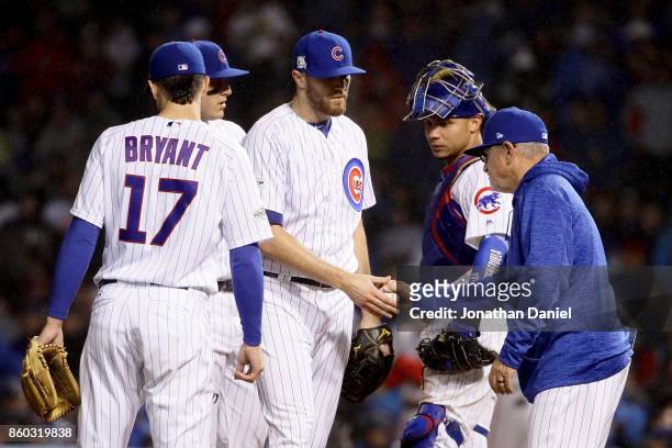 Manager Joe Maddon of the Chicago Cubs relieves Wade Davis in the eighth inning during game four of the National League Division Series against the...