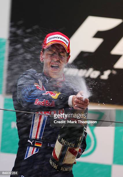Sebastian Vettel of Germany and Red Bull Racing celebrates on the podium after winning the Chinese Formula One Grand Prix at the Shanghai...