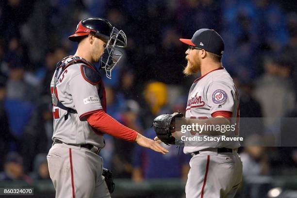 Matt Wieters and Sean Doolittle of the Washington Nationals celebrate after defeating the Chicago Cubs 5-0 in game four of the National League...