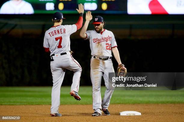 Trea Turner and Daniel Murphy of the Washington Nationals celebrate after defeating the Chicago Cubs 5-0 in game four of the National League Division...