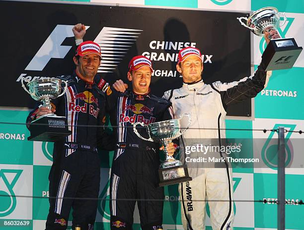 Race winner Sebastian Vettel of Germany and Red Bull Racing celebrates with second placed team mate Mark Webber of Australia and Red Bull Racing and...