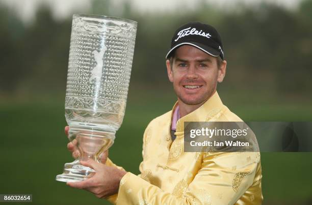 Scott Strange of Australia celebrates with the trophy after winning the final round of the Volvo China Open at the Beijing CBD International Golf...