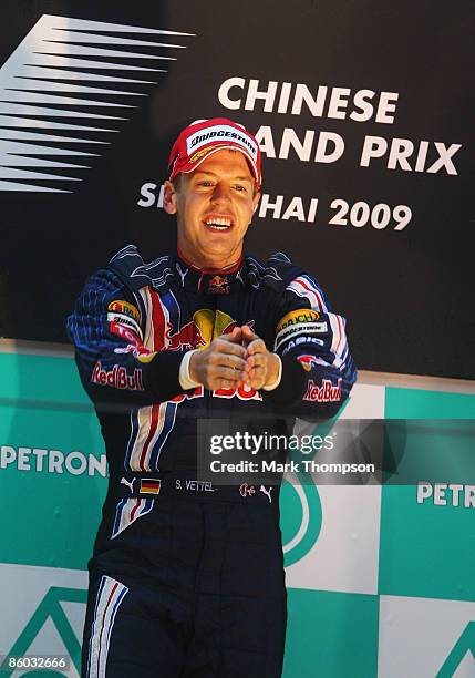 Sebastian Vettel of Germany and Red Bull Racing celebrates on the podium after the Chinese Formula One Grand Prix at the Shanghai International...